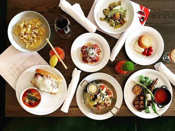 a table at Cardinale with plates of food one of the best italian restaurants in calgary